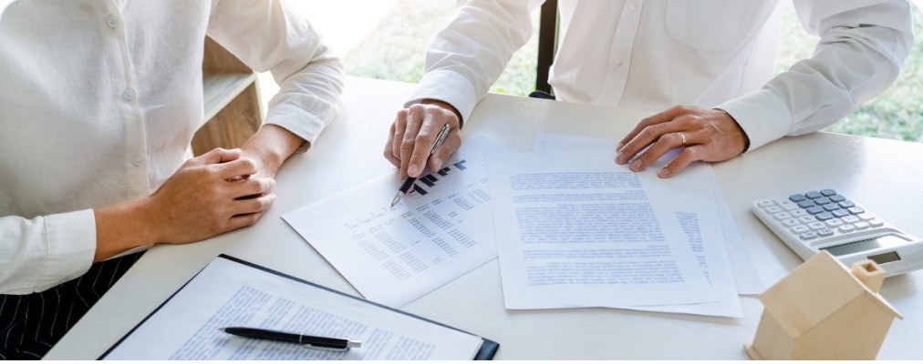 Two people reviewing financing paperwork